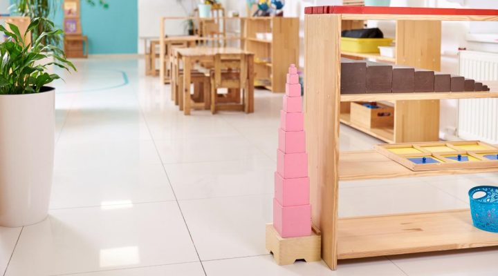 In this episode of Montessori Talks, we discuss the inspiring story of Najee and Sesealy Owens, the new owners of Decatur Montessori School in Atlanta. 
Image shows a beautiful Montessori classroom with the pink tower as the central focus of the image. The red rods and the brown stair are also visible. There are tables with chairs, plants and shelving in the background. 